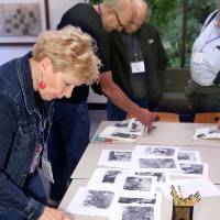 An alumna looking at old photos from 1968.